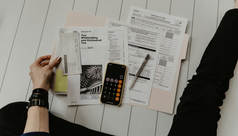 Business documents and financial paperwork spread across a desk, representing bank due diligence materials
